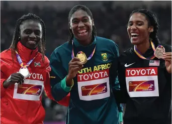  ??  ?? LET’S SHOW OFF, LADIES: Silver medalist Francine Niyonsaba of Burundi, Caster Semenya and bronze medalist Ajee Wilson of the USA pull out their biggest smiles on the podium in London on Sunday.