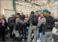  ?? (AP/Mahmoud Illean) ?? Palestinia­ns scuffle with Israeli forces Sunday during a protest against the planned visit of Israeli President Isaac Herzog to Hebron’s holiest site, known to Jews as the Tomb of the Patriarchs and to Muslims as the Ibrahimi Mosque in the Israeli controlled part of the West Bank city of Hebron.