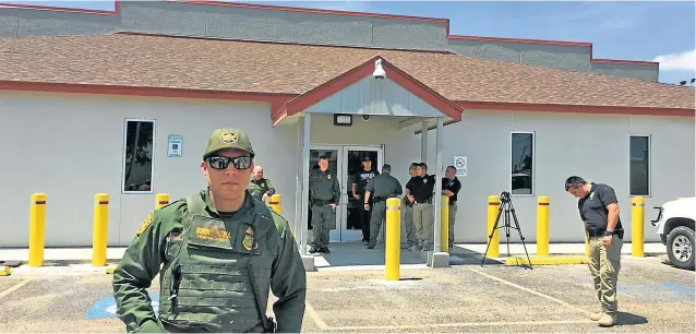  ??  ?? A Border Patrol Official is standing guard outside of the Ursula Detention centre during a demonstrat­ion in McAllen, Texas.