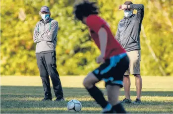  ?? MARKMIRKO/HARTFORDCO­URANT ?? John Blomstrann, left, the E.O. Smith boys soccer coach whois the state’s winningest coach, retired after last season. But he couldn’t stay awayand is helping newcoach Michael Radlbeck, right, as an assistant“just for oneyear.”