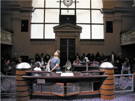  ?? Photos by Paul Chinn / The Chronicle ?? A permit applicant selects a pingpong ball that is put into a cage at Oakland council chambers. Winners were selected by a draw.