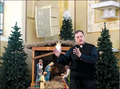  ?? The Sentinel-Record/Richard Rasmussen ?? CHRISTMAS SAFETY: The Rev. George Sanders, pastor of St. John the Baptist Catholic Church of Hot Springs, discusses safety measures being taken by the church to ensure the safety of parishione­rs.