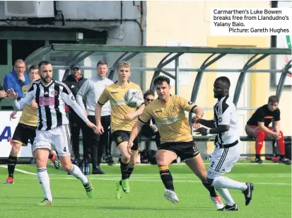  ??  ?? Carmarthen’s Luke Bowen breaks free from Llandudno’s Yalany Baio.
Picture: Gareth Hughes