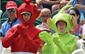  ??  ?? Uh-oh! Fans dressed as Teletubbie­s cheer on Katie Boulter in vain