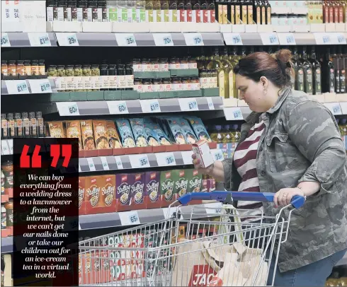  ?? PICTURES: PA WIRE ?? ALRIGHT JACK?:Customers shop in Tesco’s new back to basics Jack’s store – are smaller shops the future, and salvation, of the high street?