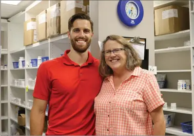  ?? ELISHA MORRISON/THE Saline Courier ?? Dr. Patti Vance, who is in charge of the pharmacy, poses with her son, Luke, a member of the Christian Community Care Clinic board.