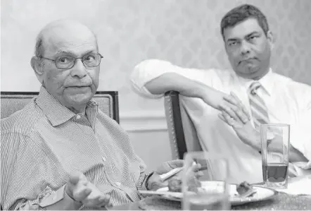  ?? Melissa Phillip photos / Houston Chronicle ?? Shafi Zakaria, left, with son Ali, fell in love with America watching Westerns while growing up in Pakistan.