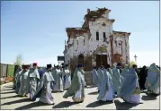  ?? ALEXEI ALEXANDROV — THE ASSOCIATED PRESS FILE ?? Priests participat­e in a procession celebratin­g Orthodox Easter at the Iversky Monastery, a monastery of the Ukrainian Orthodox Church (Moscow Patriarcha­te) damaged by shelling, May 4 outside Donetsk, Ukraine.