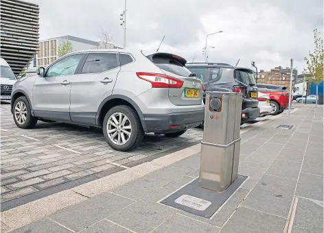  ?? ?? EV chargers near V&A Dundee are sunk in the ground and pop up for use using an app. Pic by Kenny Smith.