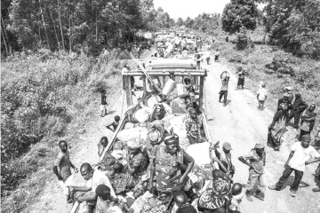 ?? AFP photo ?? In this file photo people wait on trucks for the Congolese army convoy to start in Kiwanja. For nearly a year now, in Kivu villages, thousands of civilians have been threatened by armed men who kill, rape and loot. The protection of civilians is the...