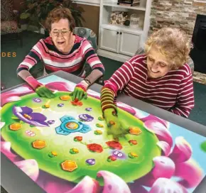  ?? THE VIRGINIAN ?? Residents at The Virginian senior-living community in Fairfax, Va., play a game that’s part of the an interactiv­e system designed to boost cognition, movement and social interactio­n.