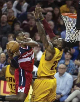  ?? PHIL LONG — THE ASSOCIATED PRESS ?? Washington’s John Wall drives past LeBron James for a basket during the first half.