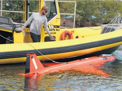  ?? CARLINE JEAN/SOUTH FLORIDA SUN SENTINEL ?? A U.S. military drone that washed up on Boynton Beach is towed to Harvey E. Oyer Jr. Park.