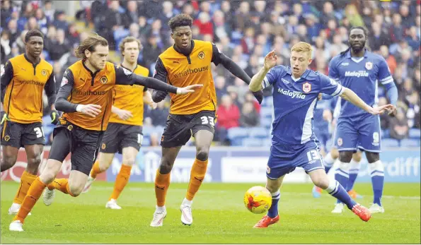  ?? PICTURES: Action Images ?? WOLF PACK: Cardiff City’s Eoin Doyle is hunted down by Wolverhamp­ton Wanderers’ Richard Stearman (left) and Dominic Iorfa