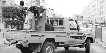  ??  ?? A Yemeni loyalist fighters, backed by Saudi Arabia and the United Arab Emirates patrols the streets of central Aden. Forces hostile to Huthi rebels have sent reinforcem­ents to the port of Hodeida frontline, in the western part of Yemen, amid escalating tensions between loyalist and rebel fighters. — AFP photo