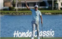  ?? The Associated Press ?? Q Matt Jones, of Australia, raises his ball after winning the Honda Classic Sunday in Palm Beach Gardens, Fla.