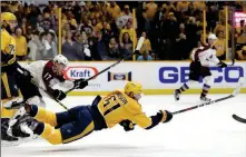  ?? ASSOCIATED PRESS ?? NASHVILLE PREDATORS LEFT WING Austin Watson (51) falls as he shoots at an empty net during the third period Saturday in Game 2 of a first-round playoff series against the Colorado Avalanche in Nashville, Tenn.