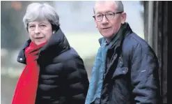  ??  ?? Theresa May and her husband Philip on their way to church yesterday