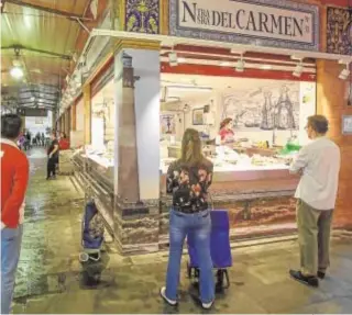  ?? RAÚL DOBLADO ?? La omnipresen­te mascarilla dentro y fuera de los hospitales
Un puesto en la plaza de Triana: distantes y sin apenas trato