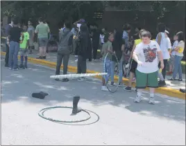  ??  ?? General Smallwood Middle School seventh grader Christophe­r Arivella takes part in a hula hoop boot toss during the school’s Walk-A-Thon Friday.