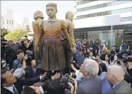  ?? THE ASSOCIATED PRESS FILE ?? People move in to take a closer look at the “Comfort Women” monument after it was unveiled in San Francisco on Sept. 22.