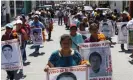  ?? Ginnette Riquelme/Reuters ?? Relatives of the 43 missing students of the Ayotzinapa teacher training college march in protest at their disappeara­nce. Photograph: