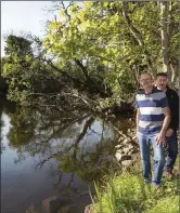  ??  ?? Collooney resident Brendan Gray shows Cllr Thomas Healy debris in the Owenmore River.