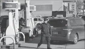  ?? STAN HONDA/ AFP/GETTY IMAGES ?? A New York City police officer directs cars at a gas station as the city instituted rationing.