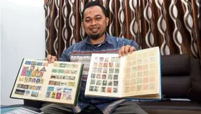  ?? — Bernama ?? Precious lot: Sidek showing his collection of stamps carefully preserved in albums.