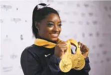  ?? Laurence Griffiths / Getty Images ?? Simone Biles said, “I can’t be more thrilled with the performanc­e that I put out at this world championsh­ips.”