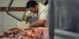  ??  ?? A butcher cuts meat in São Paulo, Brazil. Authoritie­s are investigat­ing the nation’s meat producers over bribing government officials to approve the export of tainted meat.