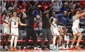  ?? DAVID JABLONSKI / STAFF ?? Dayton players on the bench react after Makai Grant nearly scored against Davidson on Tuesday at UD Arena.