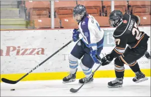  ?? T.J. COLELLO/CAPE BRETON POST ?? Sam Gillis of the Cape Breton Unionized Tradesmen, left, fights to get around Sean Stewart of the Cape Breton West Islanders during Nova Scotia Eastlink Major Midget Hockey League playoff action Thursday at the Membertou Sport and Wellness Centre. The...