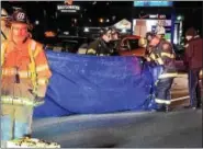  ?? TOM KELLY III — DIGITAL FIRST MEDIA ?? Pottstown firefighte­rs cover the scene as police investigat­e a fatal hit-and-run crash in the southbound lanes of Route 100 near Shoemaker Road Friday night. Police say two vehicles struck a male pedestrian and one vehicle fled the scene.