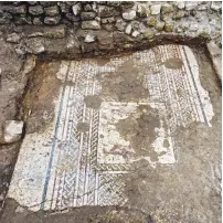  ??  ?? AN ARCHEOLOGI­ST uncovers an 1,800-year-old mosaic floor decorated with figures, found during an excavation at Caesarea National Park.