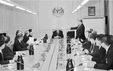  ??  ?? Najib briefed by Lim (standing) at Bangunan Perdana Putra. — Bernama photo