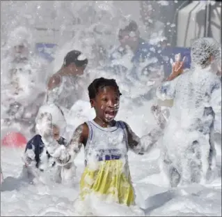  ?? PHOTOS BY JOHN RENNISON, THE HAMILTON SPECTATOR ?? Chidren play in a foam filled pool in the family zone at Supercrawl on Sunday.
