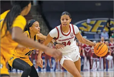  ?? Associated Press ?? Driving: Arkansas' Chrissy Carr (34) drives the ball up the court against Missouri's Katlyn Gilbert (10) in the first half of an NCAA college basketball game during the Southeaste­rn Conference Women's Tournament Thursday in Greenville, S.C.