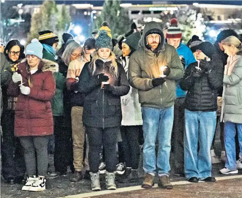  ?? ?? A vigil at the University of Idaho’s main campus in Boise to mourn the victims in Moscow. Below, floral tributes laid on the Moscow campus