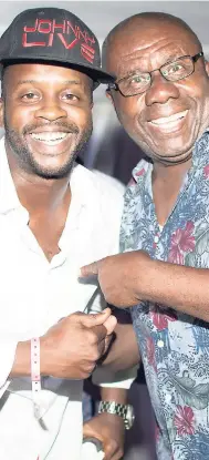  ??  ?? Christophe­r ‘Johnny’ Daley and the Jamaican King of Comedy, Oliver Samuels, share a moment backstage at the recent ‘Laugh Out Loud with Emanuella’ comedy show, held at the LIME Golf Academy on August 1.