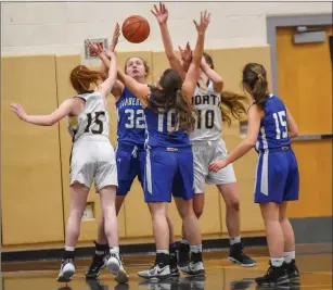  ??  ?? Cumberland juniors Juliette Vemmer (32) and Madison Zancan (10) battle for a lose ball during the Clippers’ 49-27 Open state tournament defeat to North Kingstown Thursday night.