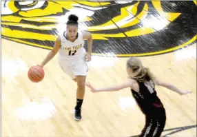  ?? MARK HUMPHREY ENTERPRISE-LEADER ?? Prairie Grove senior Larisha Crawford, shown handling the basketball against Siloam Springs, is a key player among a six-girl rotation for the Lady Tigers.