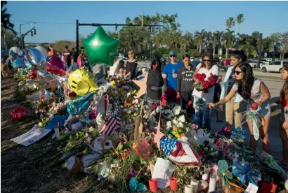  ?? Reuters ?? Well-wishers place mementos the day students and parents arrive for voluntary campus orientatio­n at the Marjory Stoneman Douglas High School, for the coming Wednesday’s reopening, following last week’s massacre in Parkland, Florida. —