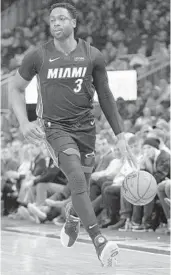  ?? MORRY GASH/AP ?? The Heat's Dwyane Wade dribbles up the court during Tuesday’s game against the Bucks at the Fiserv Forum.