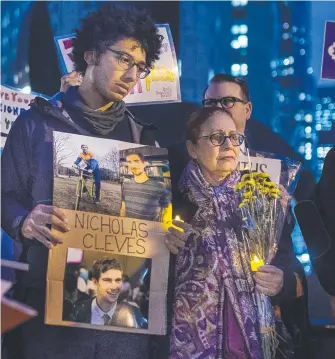  ?? Picture: AP ?? Bahij Chancey, 26, left, holds a photo of his friend Nicholas Cleves, one of the victims of the Manhattan truck attack, during an interfaith vigil for peace.