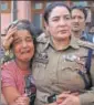  ?? AP ?? ▪ A police officer consoles the daughter of Deepak Thesoo, who was killed in a gunbattle with militants on Thursday.