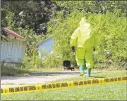  ?? Photos by Kevin Myrick/SJ ?? A member of the hazmat team went inside an Aragon home at 10 Grove St. (above) looking for a meth lab, but only found water bottles within.