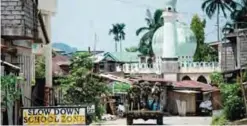  ??  ?? MARAWI: Soldiers aboard a vehicle maneuver through a street of this city on the southern island of Mindanao yesterday. —AFP