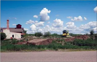  ?? NEWS PHOTO GILLIAN SLADE ?? A temporary berm is being constructe­d behind Medalta just off Industrial Ave. The City says even though there is no immediate risk of a flood, measures are being put in place while social distancing is observed, something that would be difficult to do in a rush.