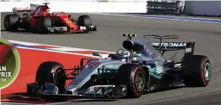  ?? AP PIC ?? Mercedes’ Valtteri Bottas takes a corner followed by Ferrari driver Sebastian Vettel in the Russian Grand Prix yesterday.